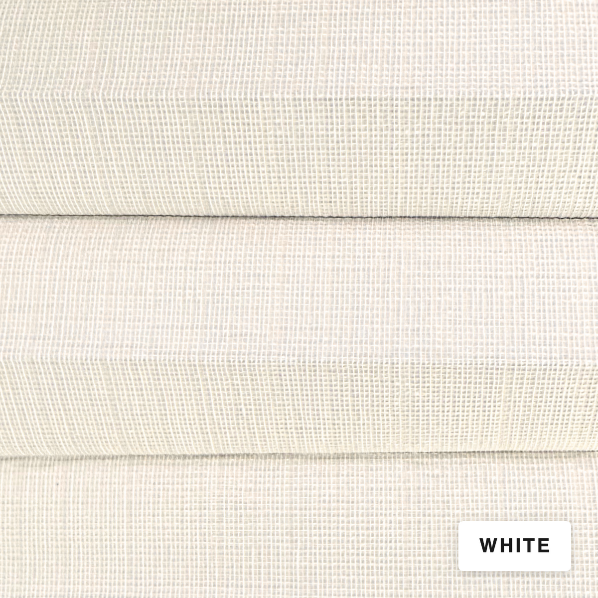 A close-up of a white woven fabric texture with three folded layers, showing the material's fine grid pattern. A small white label in the bottom right corner reads 'WHITE'.